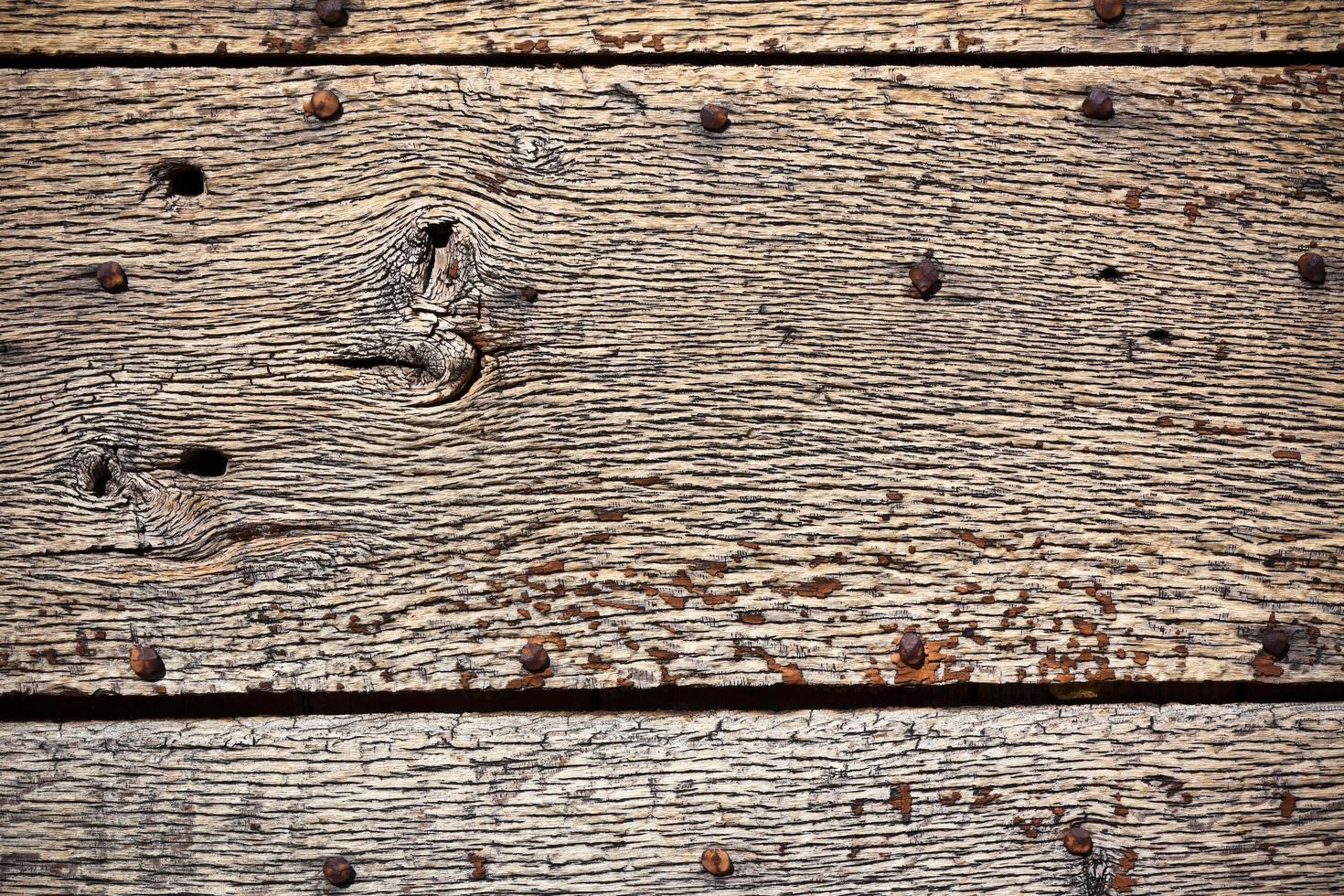 Wooden surface with old metal rivets background photo