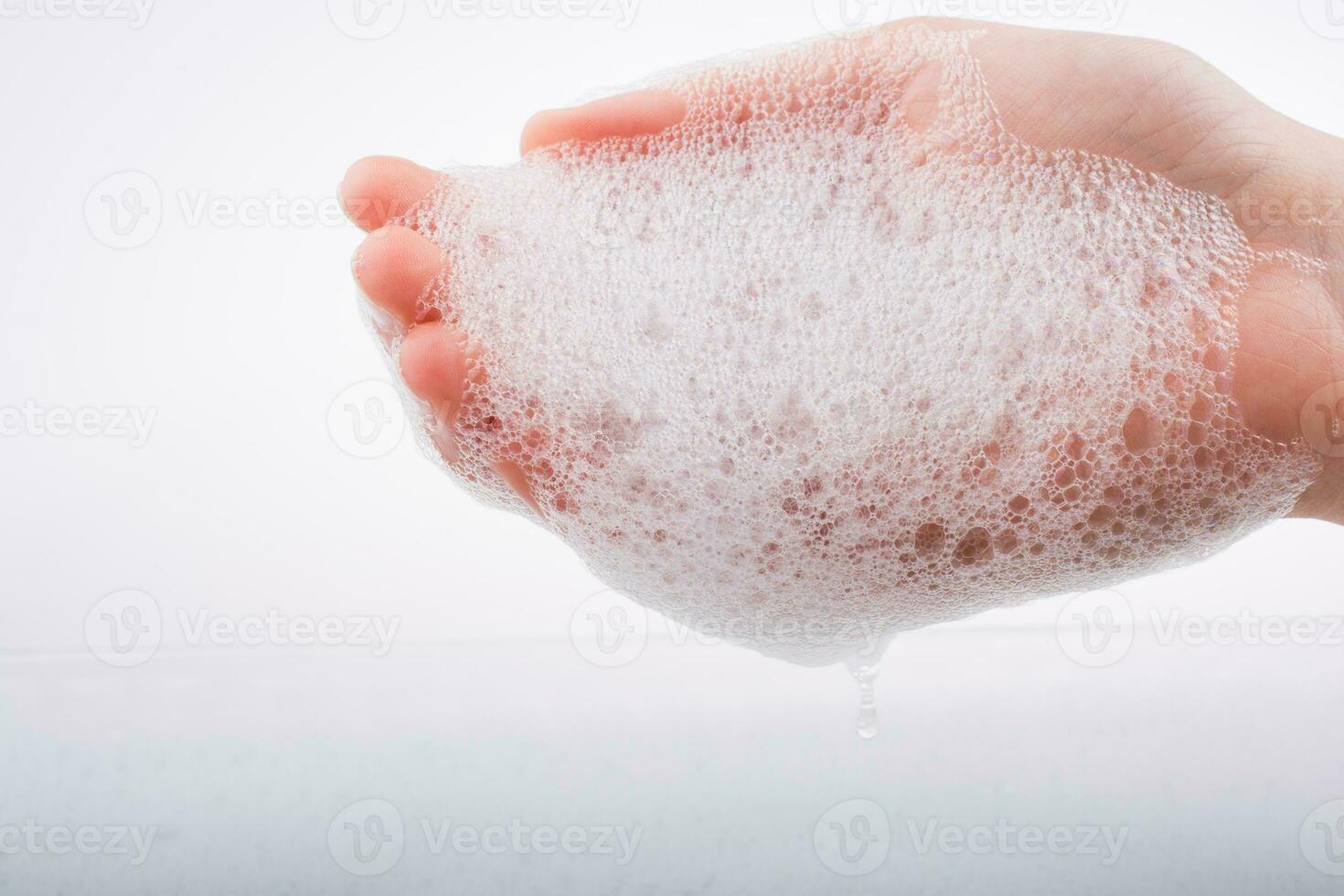 Child washing hands  in foam photo