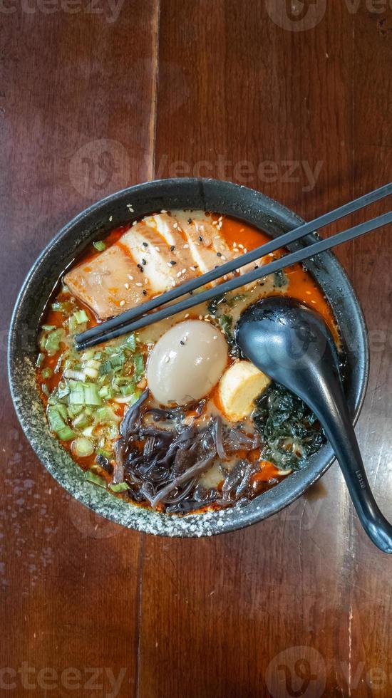 Top View. Spicy Miso Ramen. Japanese noodles with vegetables, minced roast chicken, seaweed, and boiled egg photo