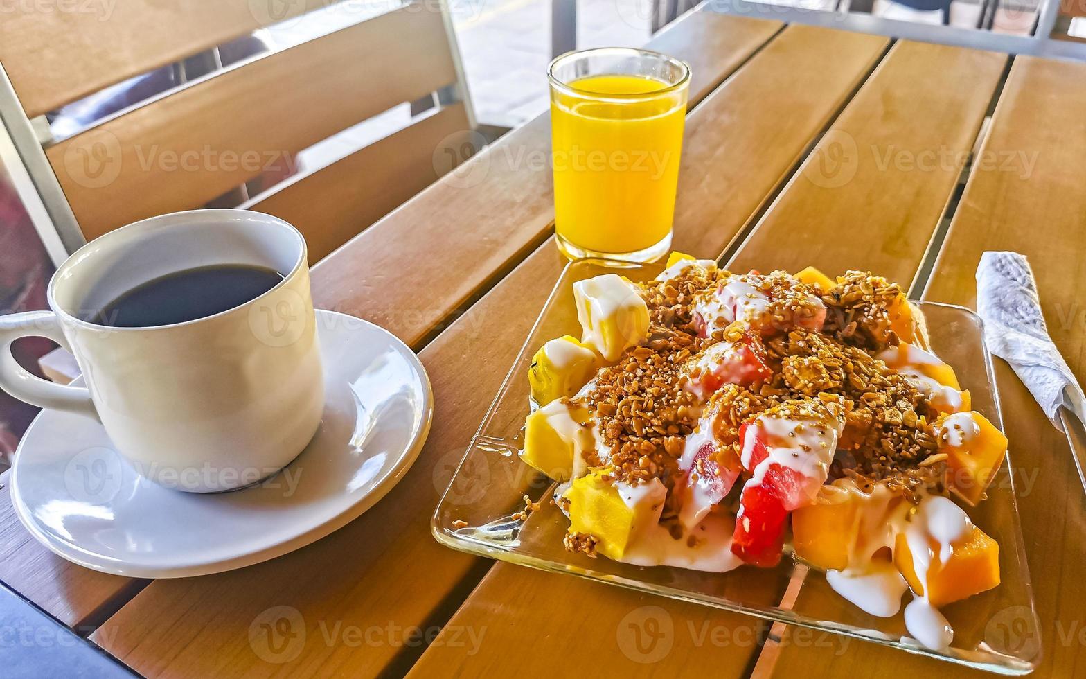 Breakfast at estaurant fruits with oatmeal orange juice and coffee. photo
