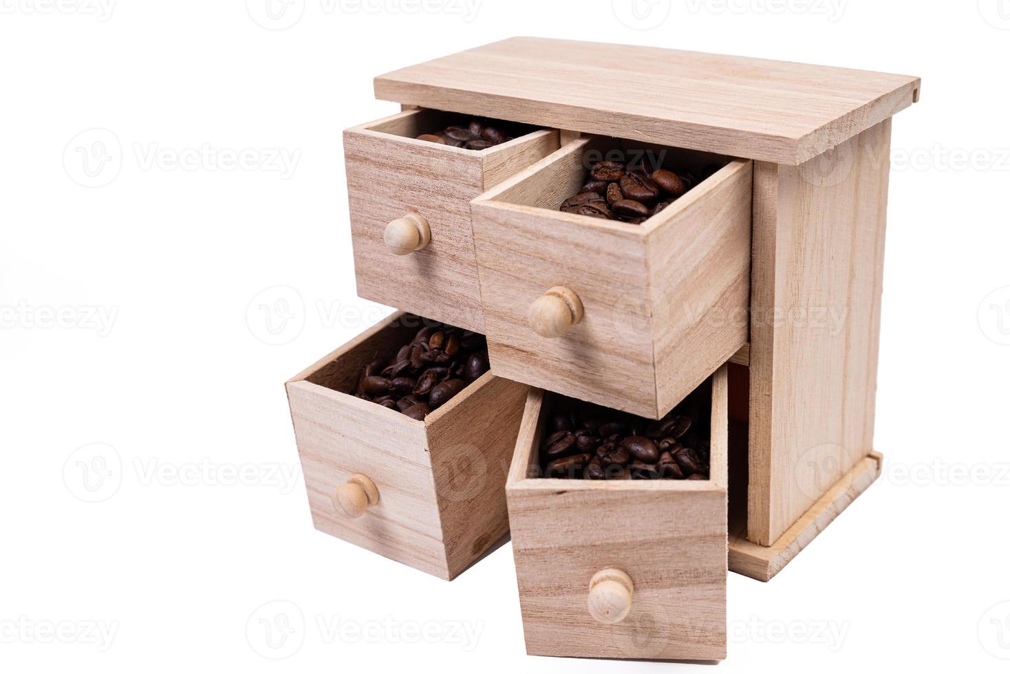 Wooden box with cells filled with coffee beans. Coffee beans scattered side by side Isolated on white background photo