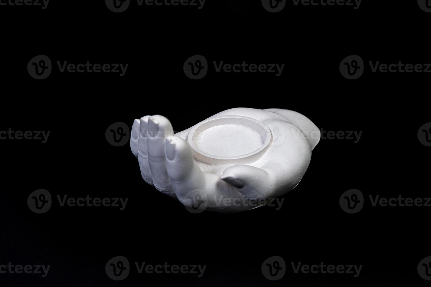 candlestick in the form of a plaster hand with candles, a plaster candlestick in the shape of a stone. tea candle. interior candle holder with your own hands photo