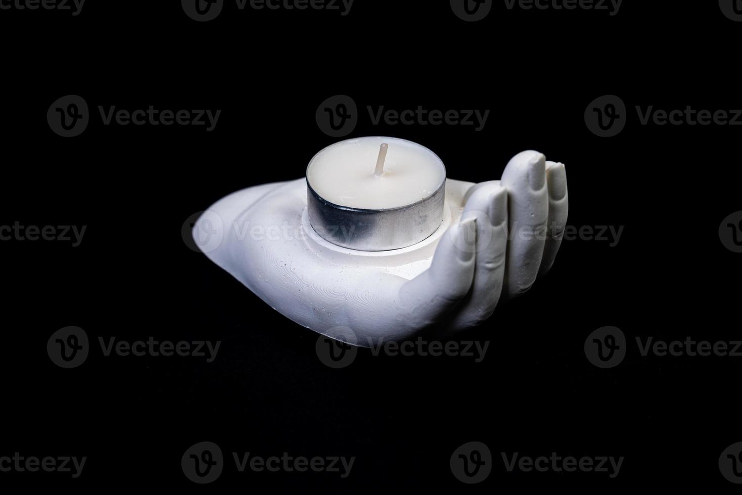candlestick in the form of a plaster hand with candles, a plaster candlestick in the shape of a stone. tea candle. interior candle holder with your own hands photo