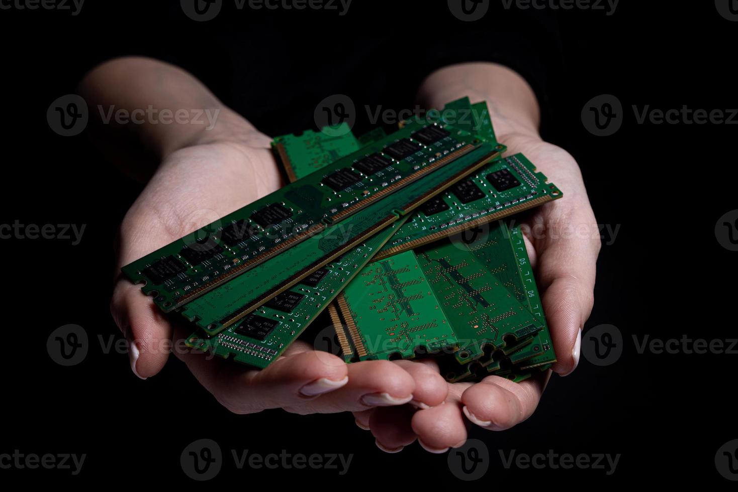 female hands hold memory computer card . american woman wearing scientist uniform holding cpu microchip at laboratory photo