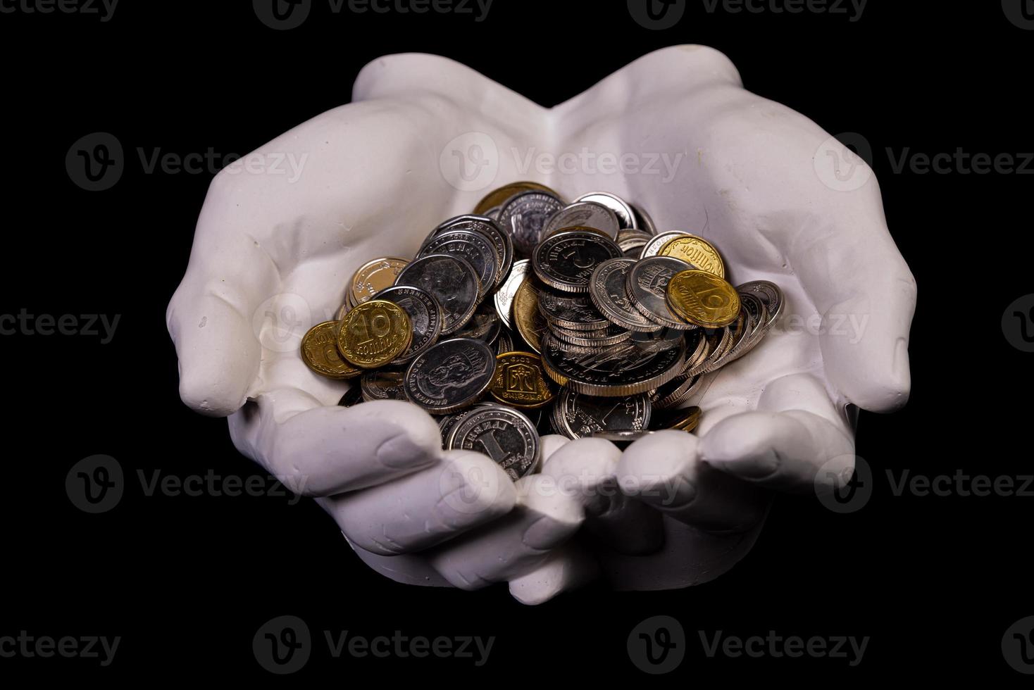 hands holding coins selective and soft focus isolated on black background with copy space. photo