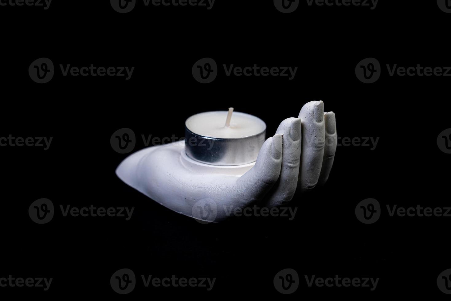 candlestick in the form of a plaster hand with candles, a plaster candlestick in the shape of a stone. tea candle. interior candle holder with your own hands photo