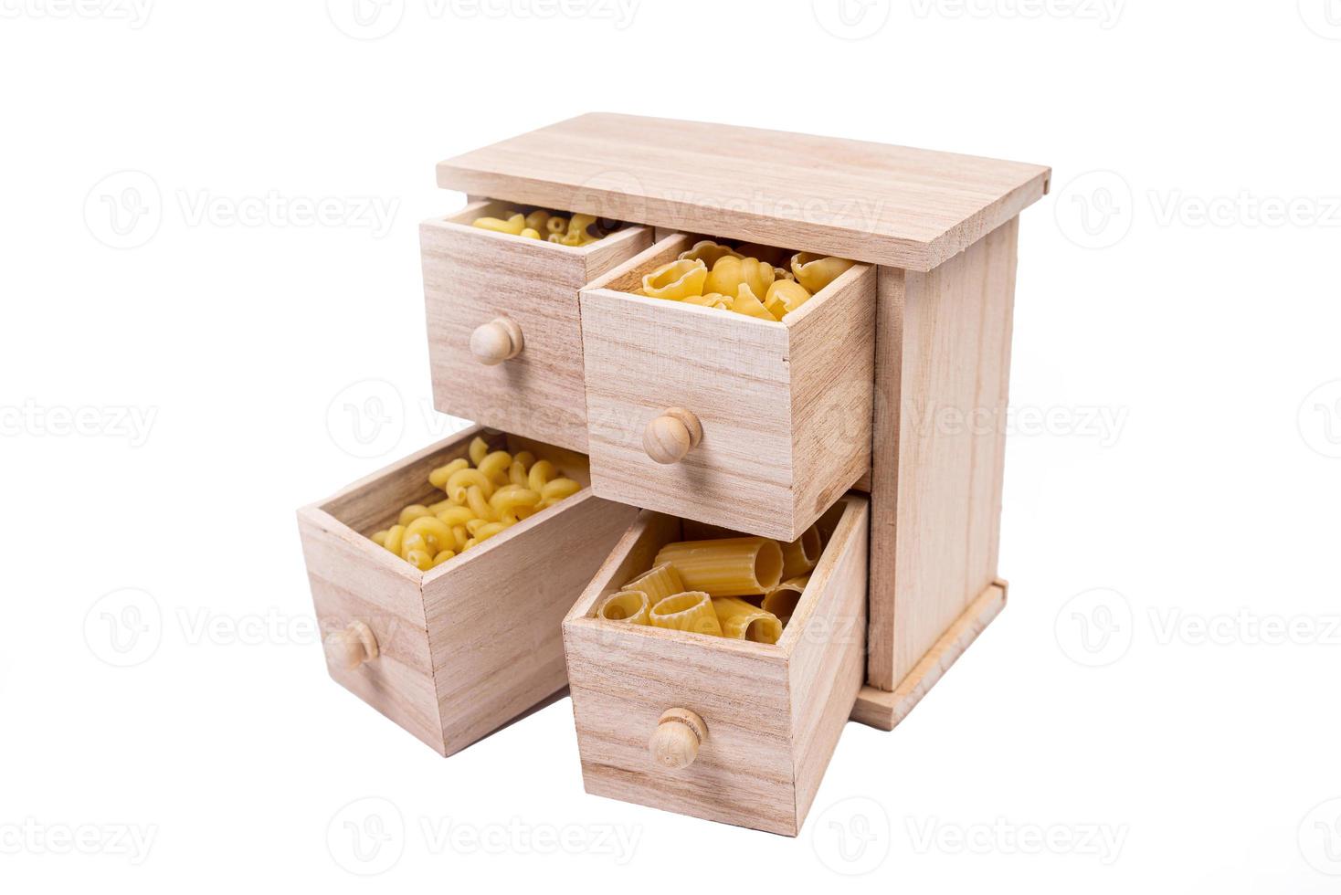 Different types of italian uncooked pasta in wooden box, whole wheat pasta, pasta, spaghetti, noodles, tagliatelle. Top view photo