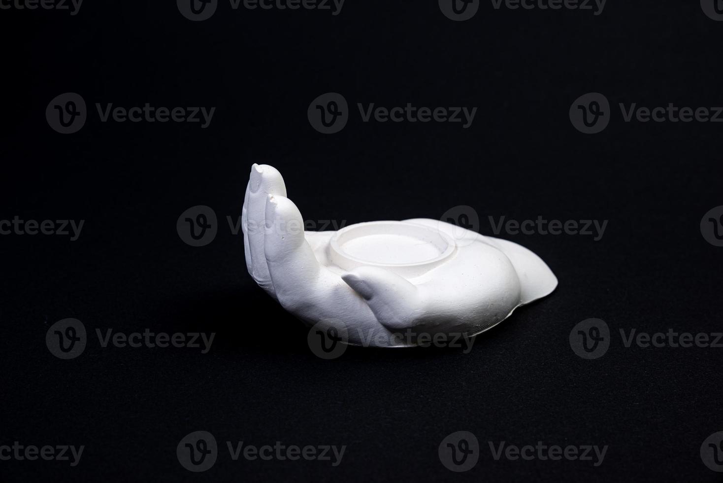candlestick in the form of a plaster hand with candles, a plaster candlestick in the shape of a stone. tea candle. interior candle holder with your own hands photo