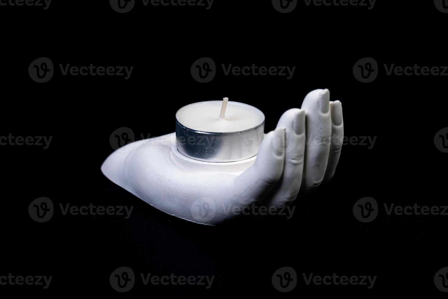 candlestick in the form of a plaster hand with candles, a plaster candlestick in the shape of a stone. tea candle. interior candle holder with your own hands photo
