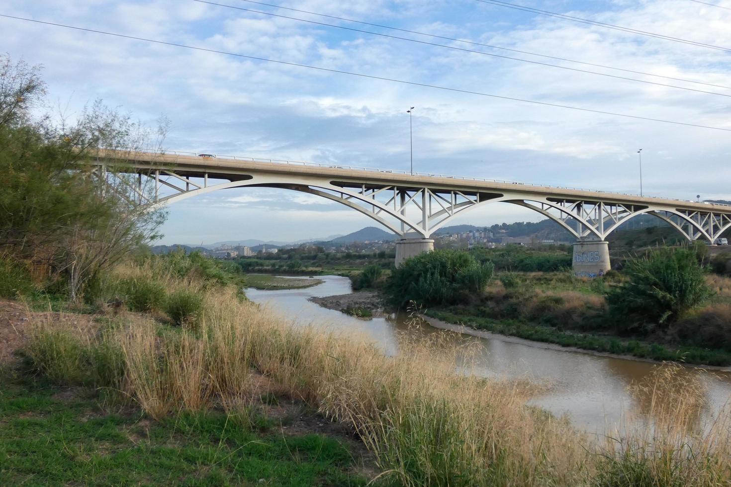 puente sobre el río llobregat, obra de ingeniería para el paso de coches, camiones y autobuses. foto