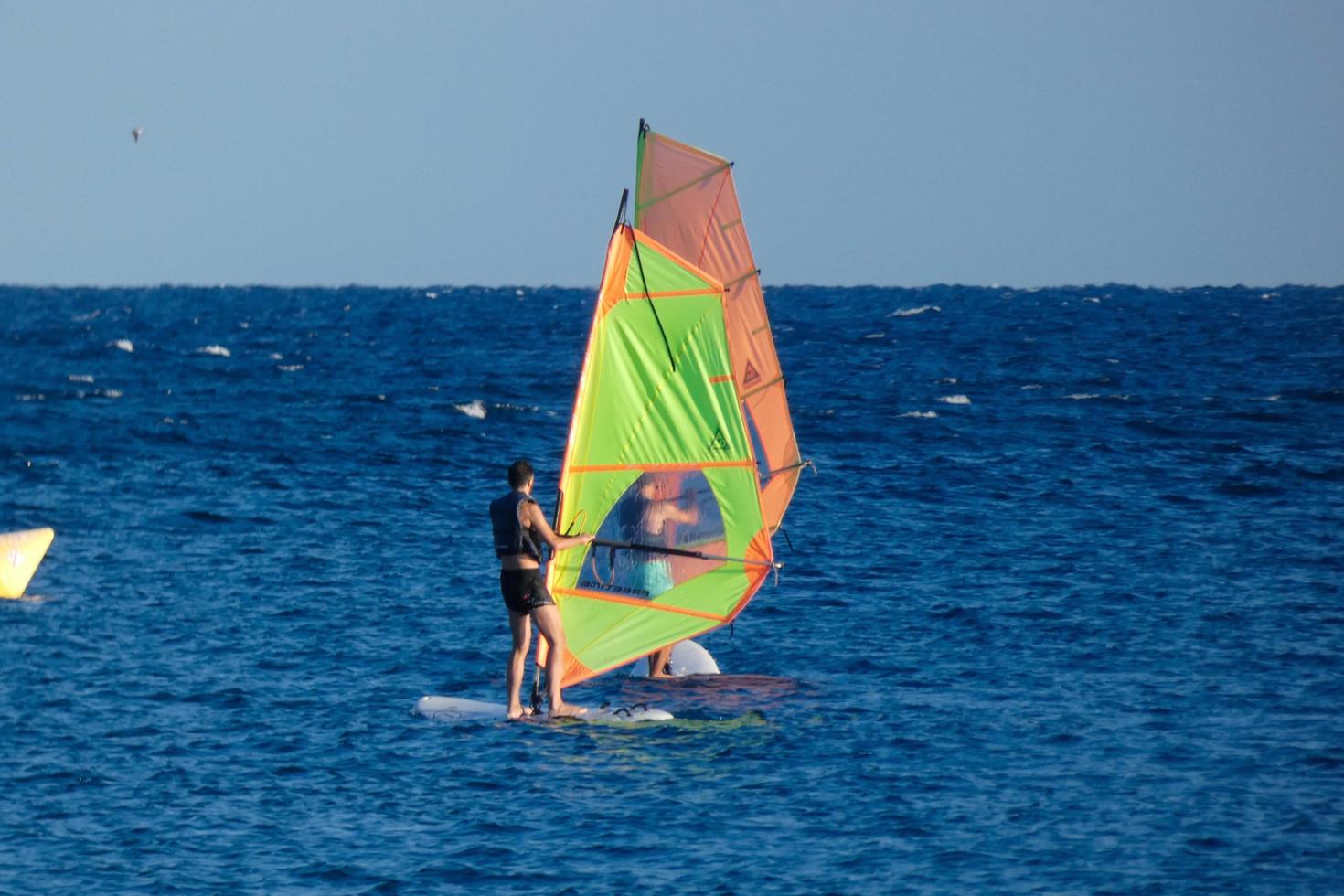 practicing windsurfing in the mediterranean sea, calm sea photo