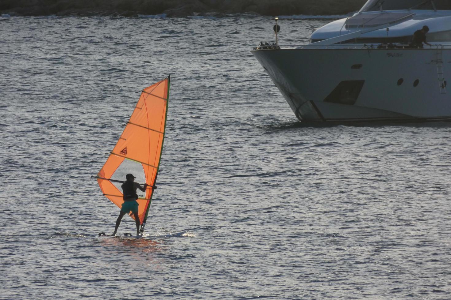 practicing windsurfing in the mediterranean sea, calm sea photo