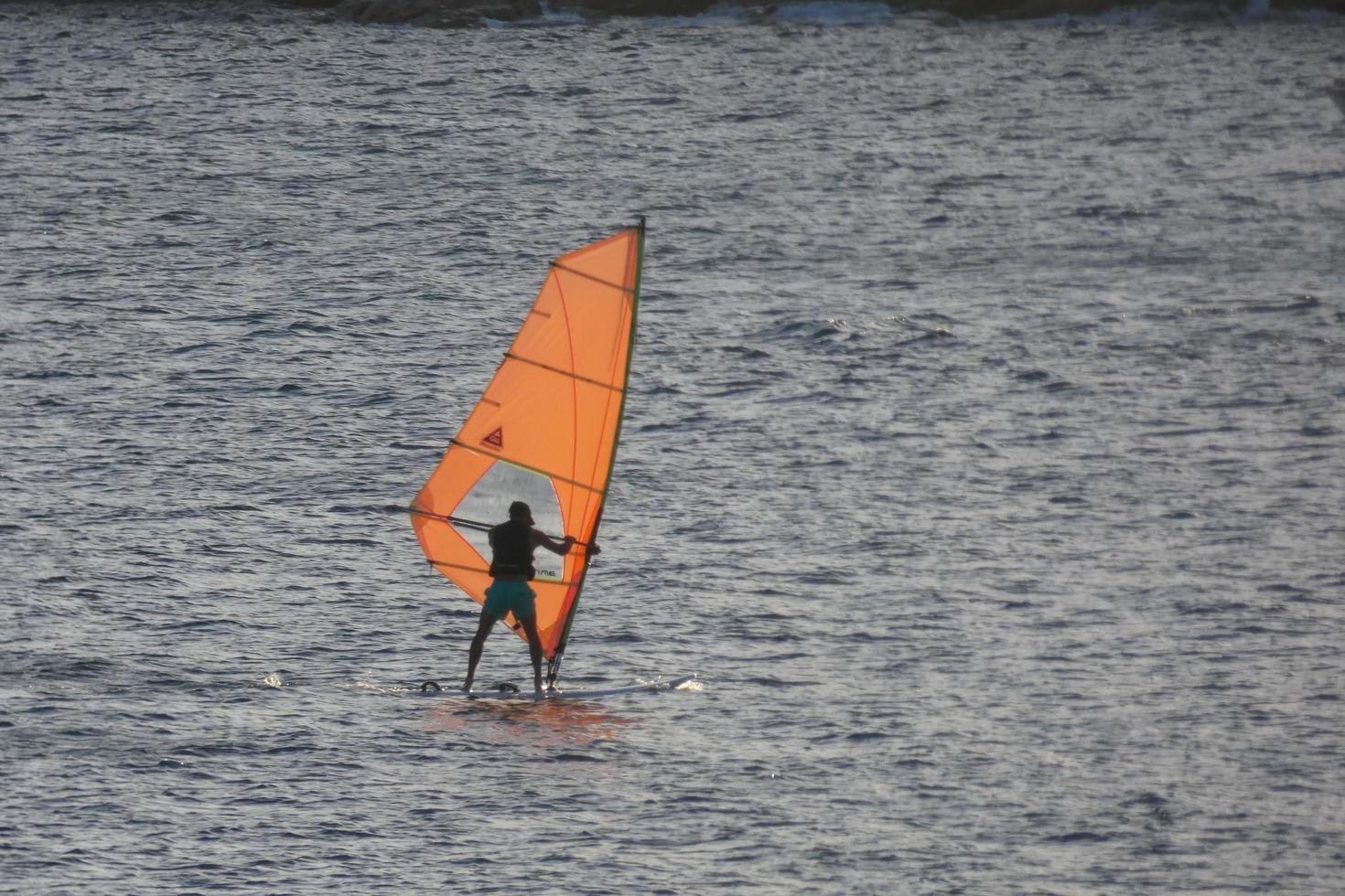 practicing windsurfing in the mediterranean sea, calm sea photo