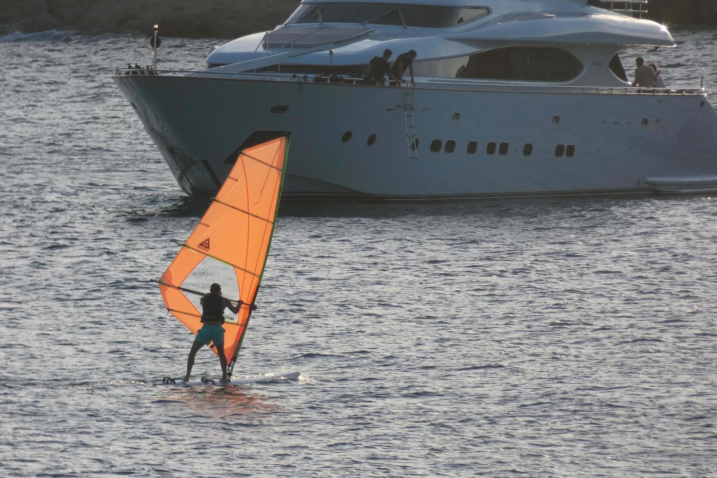 practicing windsurfing in the mediterranean sea, calm sea photo