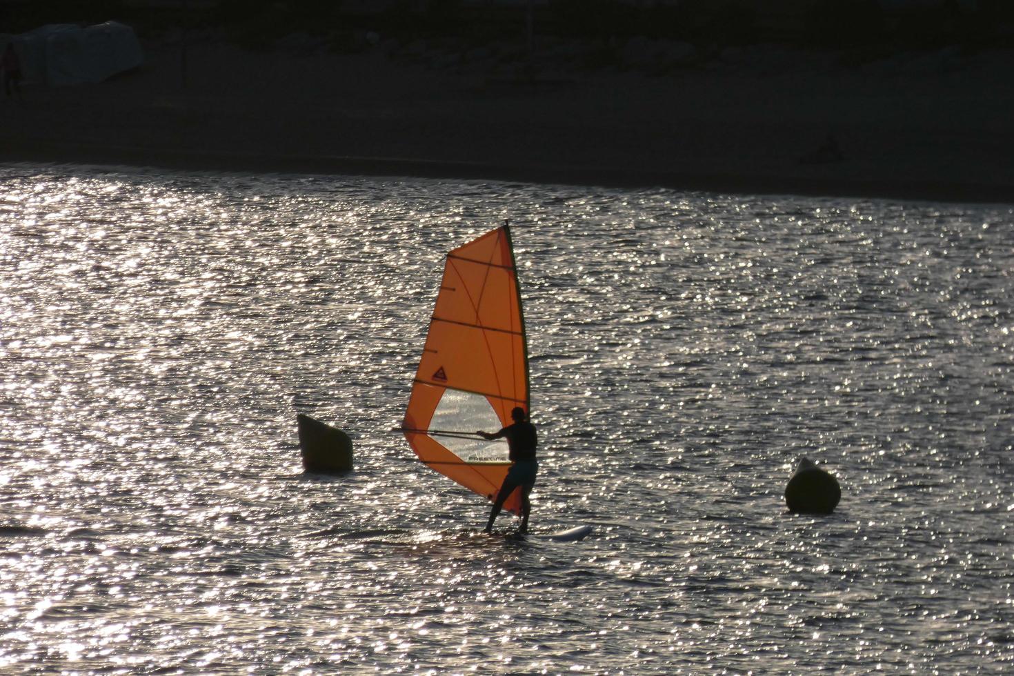 practicing windsurfing in the mediterranean sea, calm sea photo