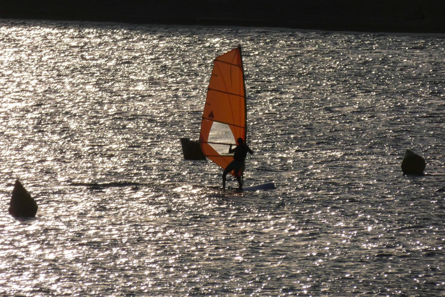 practicing windsurfing in the mediterranean sea, calm sea photo