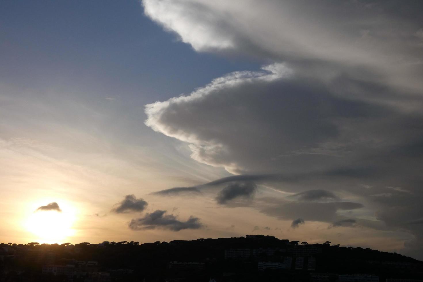 Scattered clouds in the sky indicating a change in weather. photo