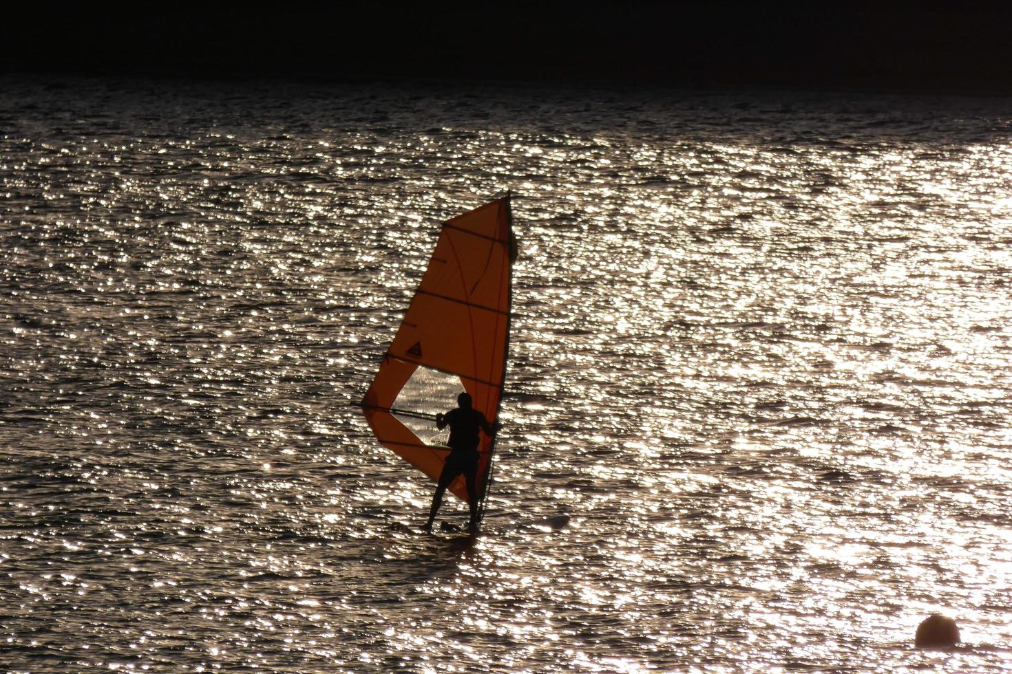 practicing windsurfing in the mediterranean sea, calm sea photo