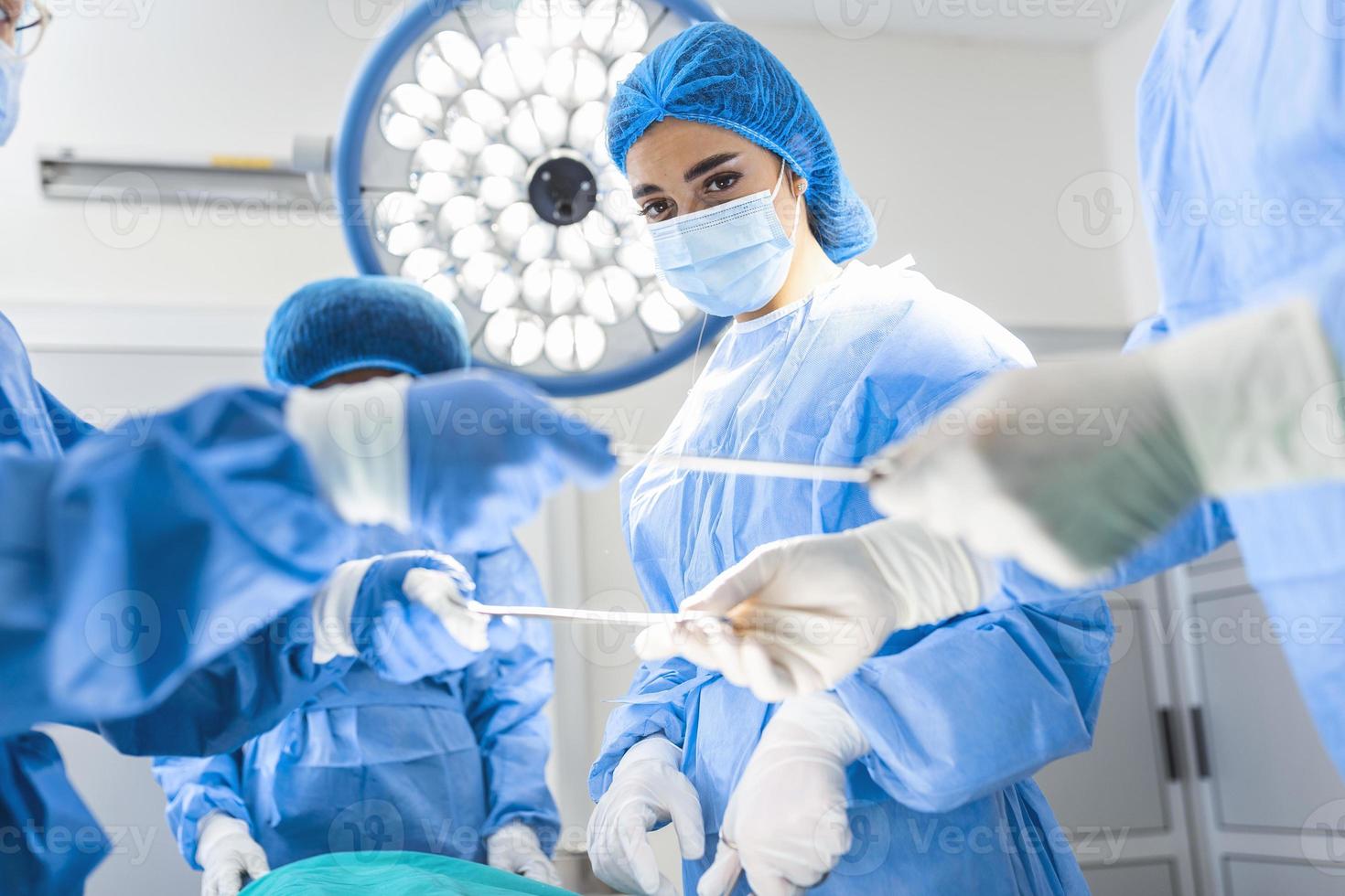 Shot in the Operating Room, Assistant Hands out Instruments to Surgeons During Operation. Surgeons Perform Operation. Professional Medical Doctors Performing Surgery. photo