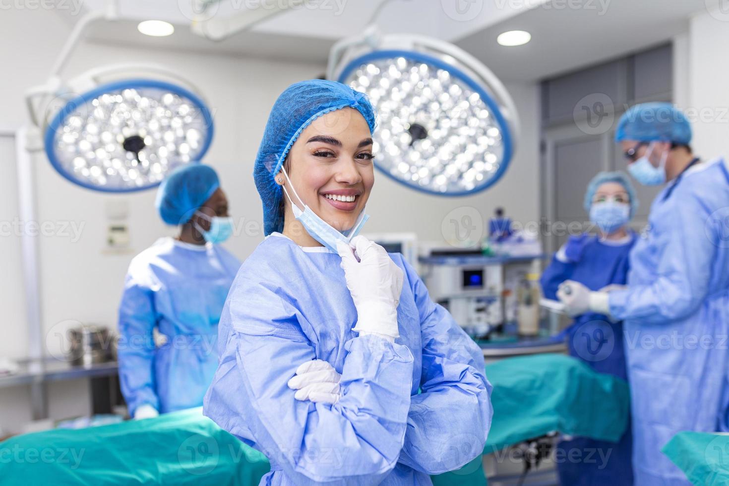 Portrait of female surgeon standing in operating room, ready to work on a patient. Woman medical worker surgical uniform in operation theater. photo