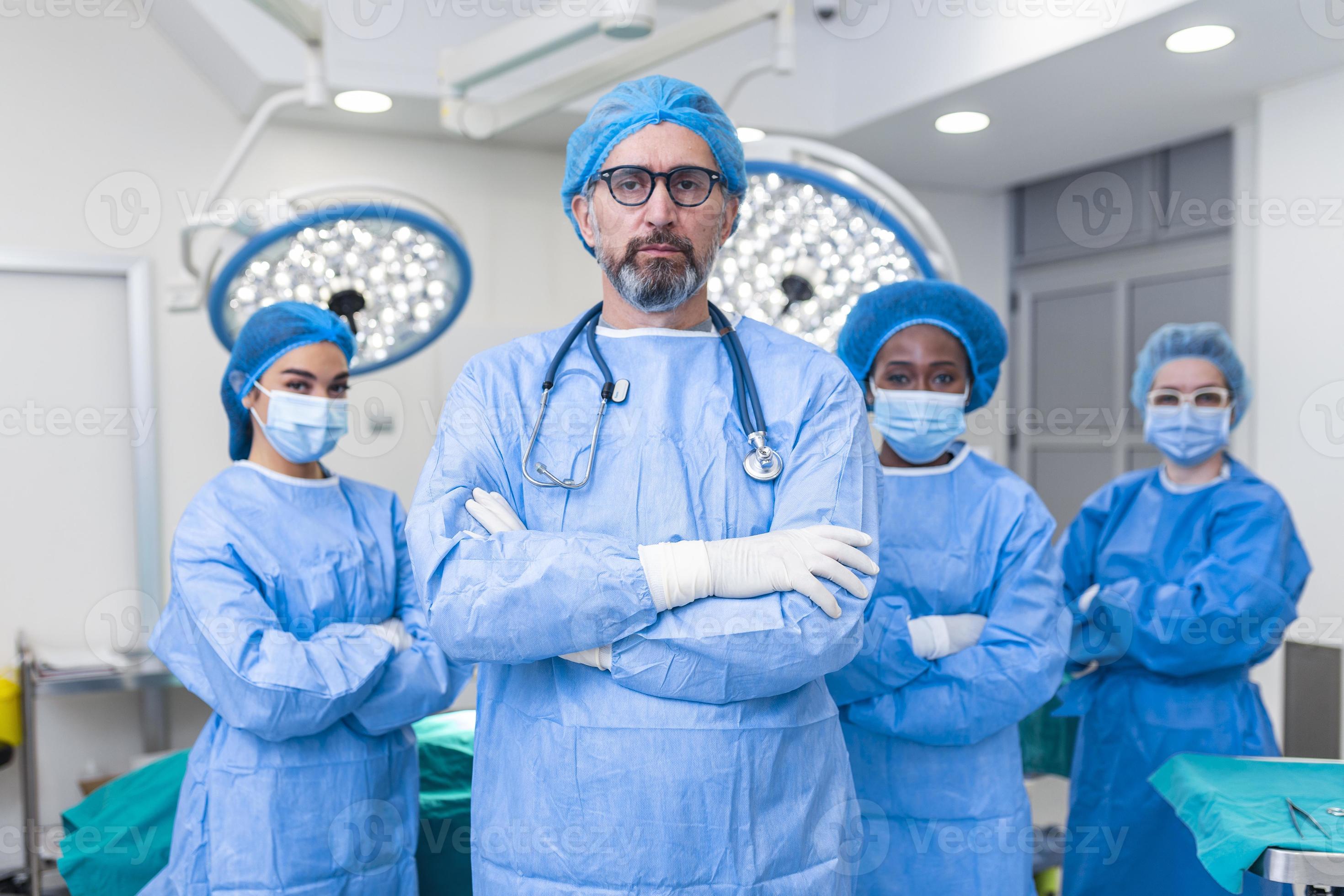 Group Of Medical Surgeons Wearing Hospital Scrubs In Operating Theatre