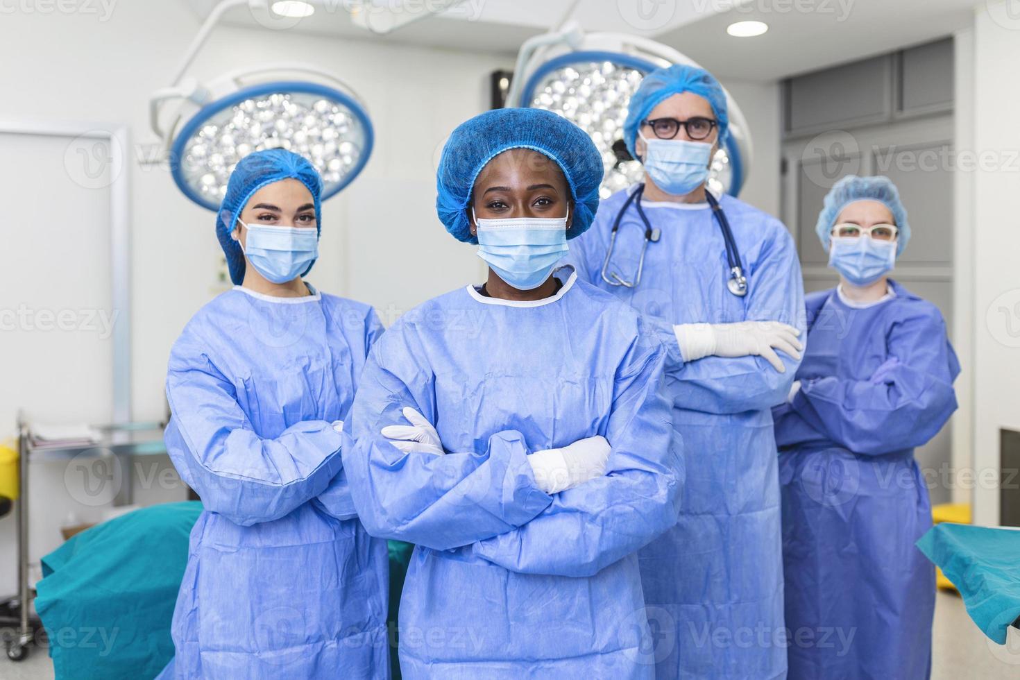 Group of medical surgeons wearing hospital scrubs in operating theatre. Portrait of successful medical workers in surgical uniform in operation theater, ready for next operation. photo
