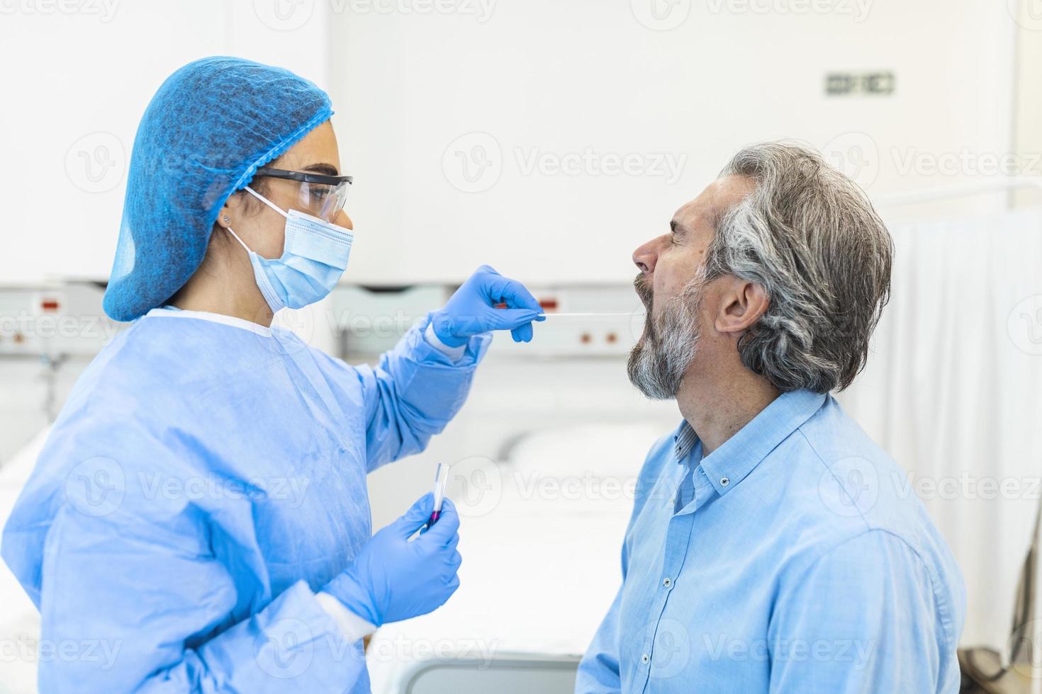 Doctor in a protective suit taking a throat and nasal swab from a patient to test for possible coronavirus infection photo
