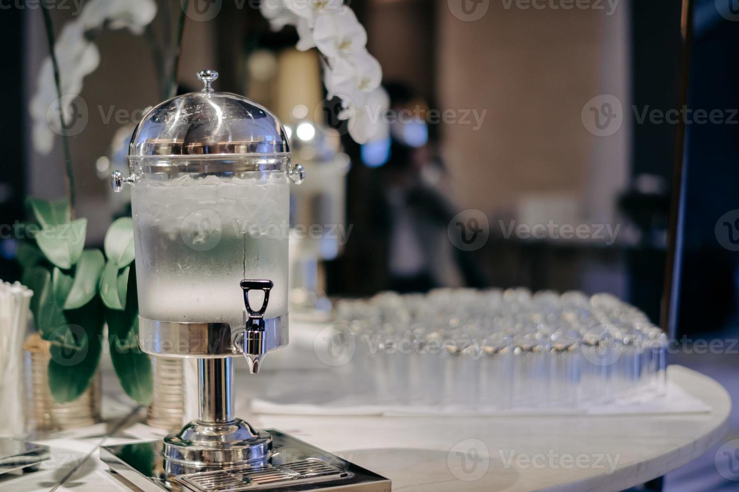Drinking water jar with tap in the hotel photo
