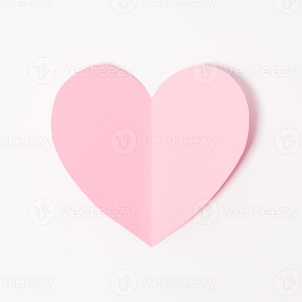 Shape of heart flying on white paper background. photo