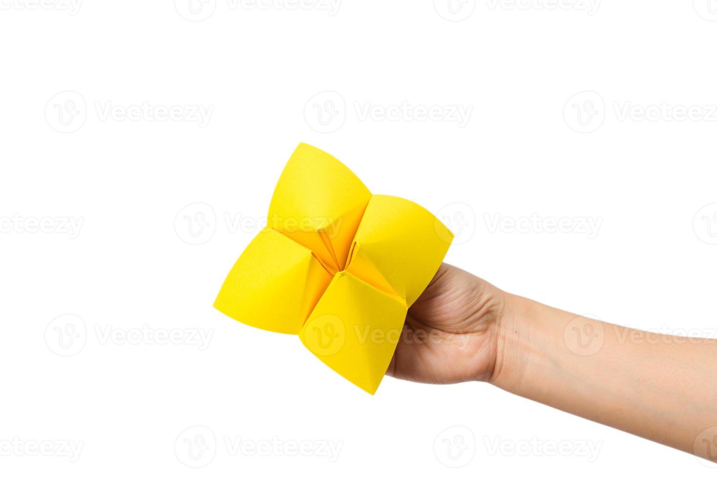 Hand in a paper fortune teller isolated on white background. photo