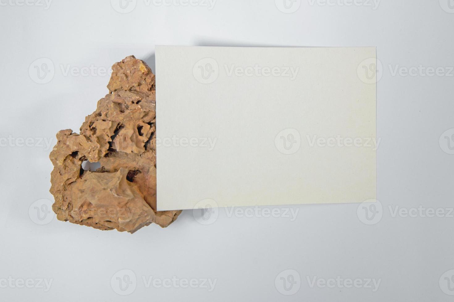 A5 paper greeting card mockup with grunge stone on white background photo