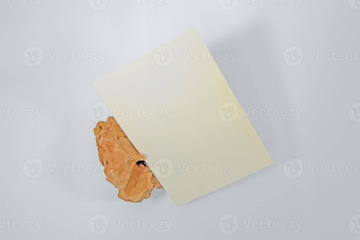 A5 paper greeting card mockup with grunge stone on white background photo