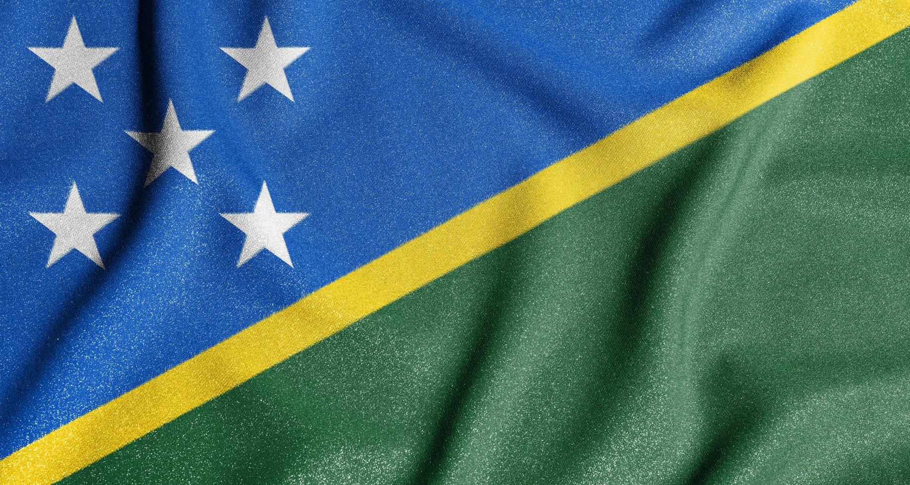 National flag of the Solomon Islands. The main symbol of an independent country. Flag of Solomon Islands. An attribute of the large size of a democratic state. photo