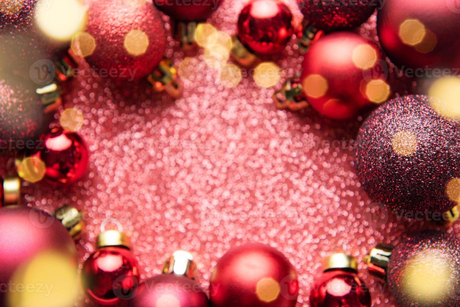 Red Christmas baubles  on red shiny background with copy space. photo