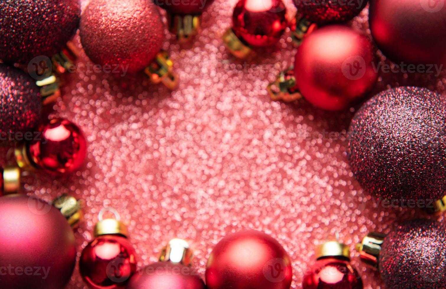 Red Christmas baubles  on red shiny background with copy space. photo