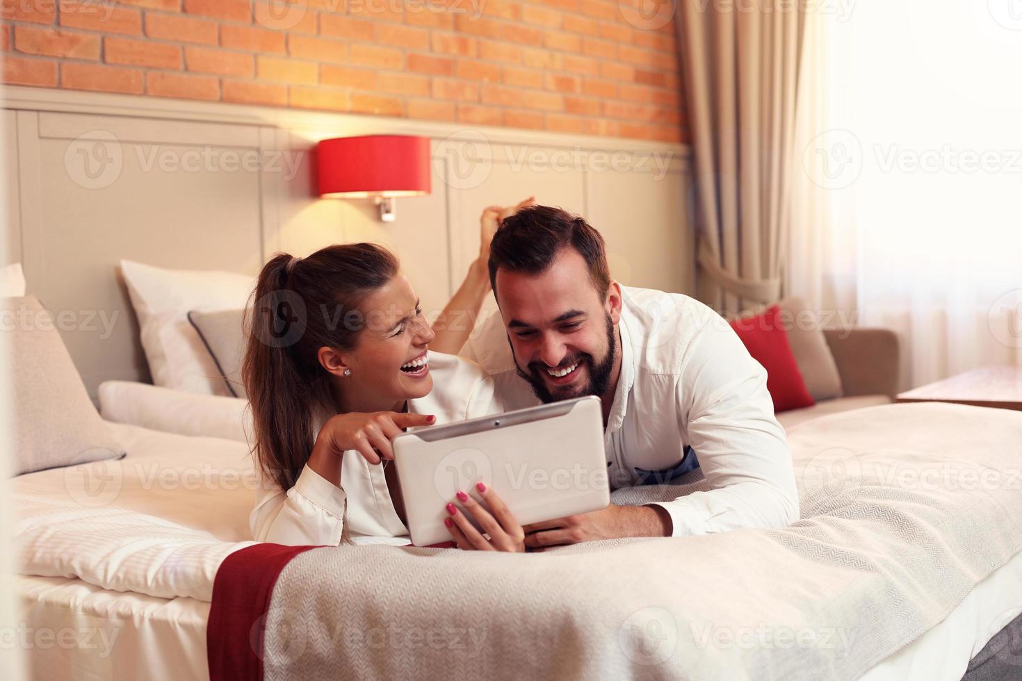 Happy couple resting in hotel room photo