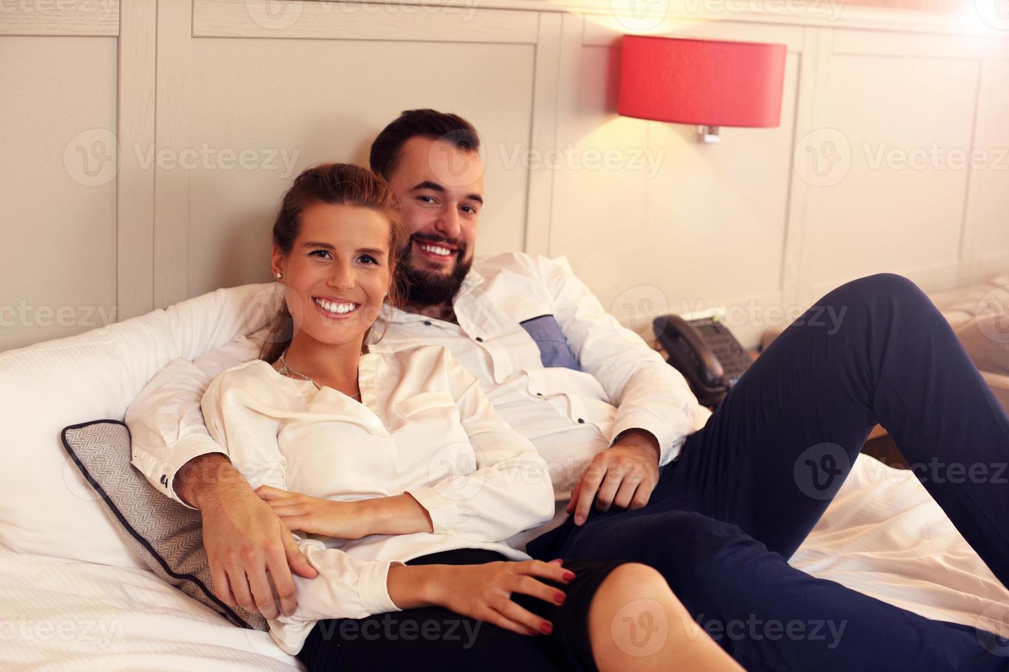 Happy couple resting in hotel room photo