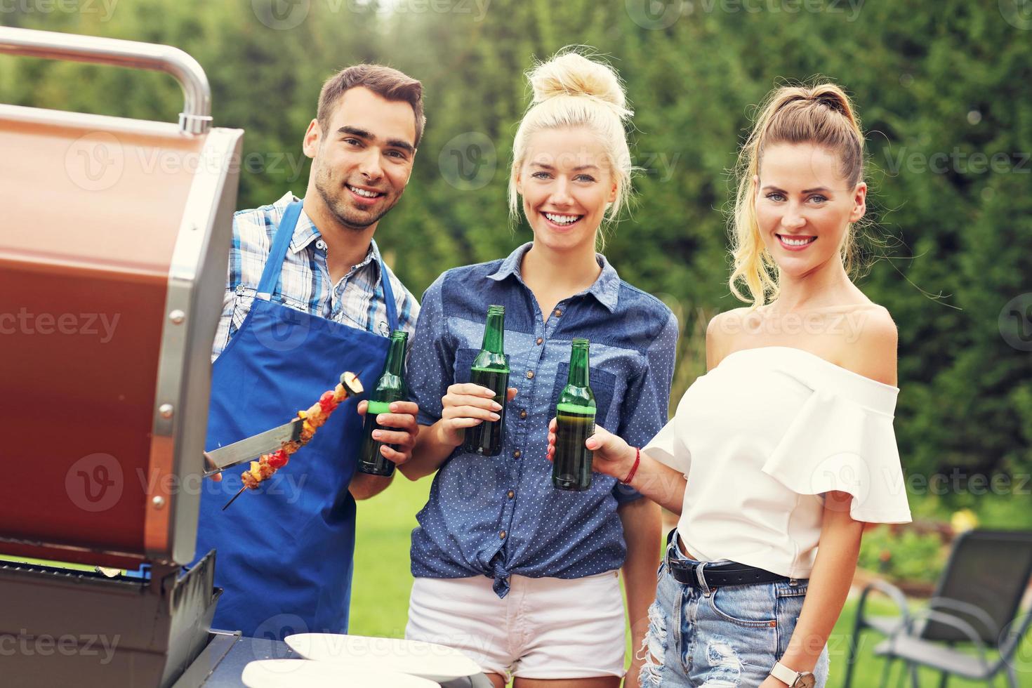 Group of friends having barbecue party photo