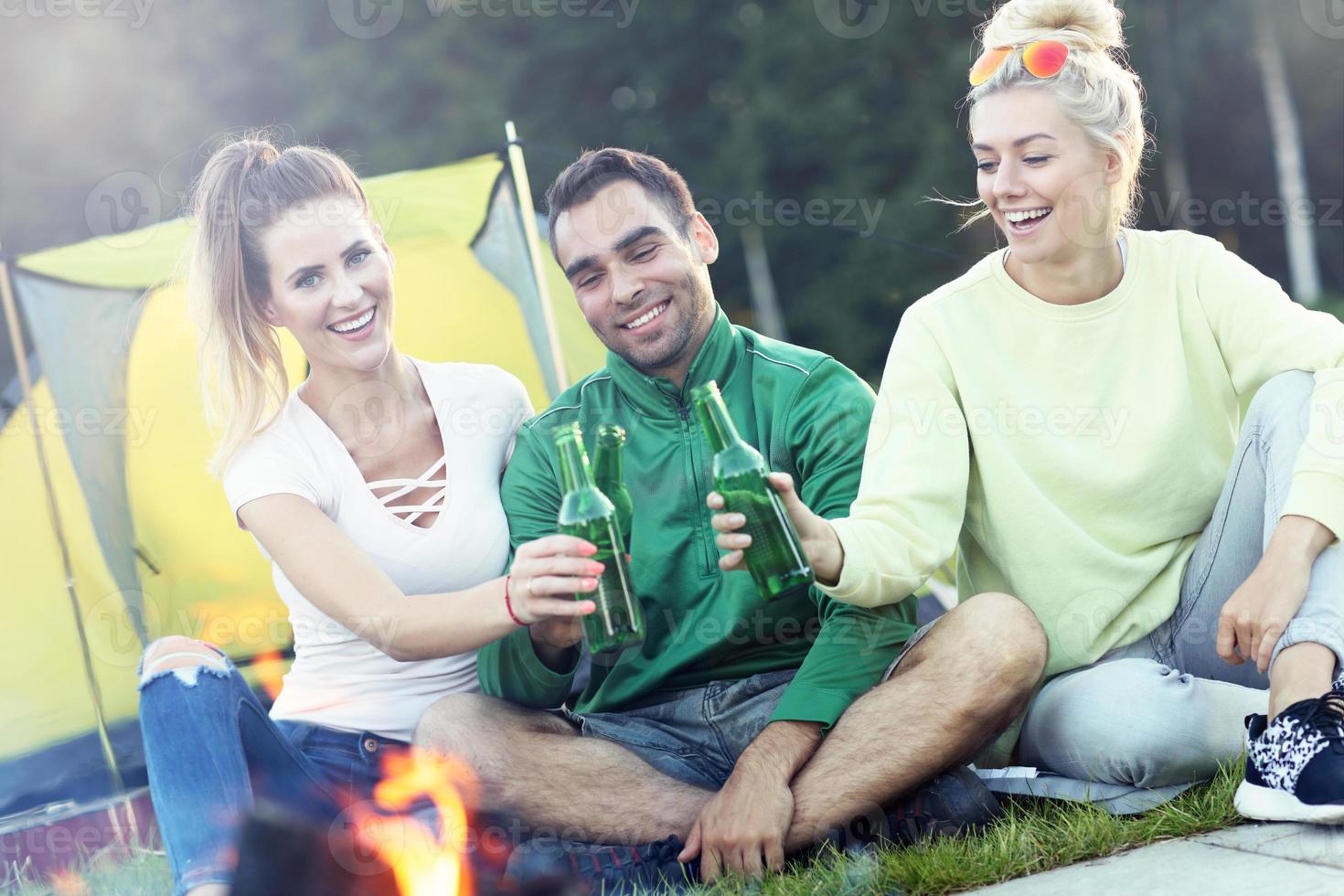 Group of friends having campfire photo