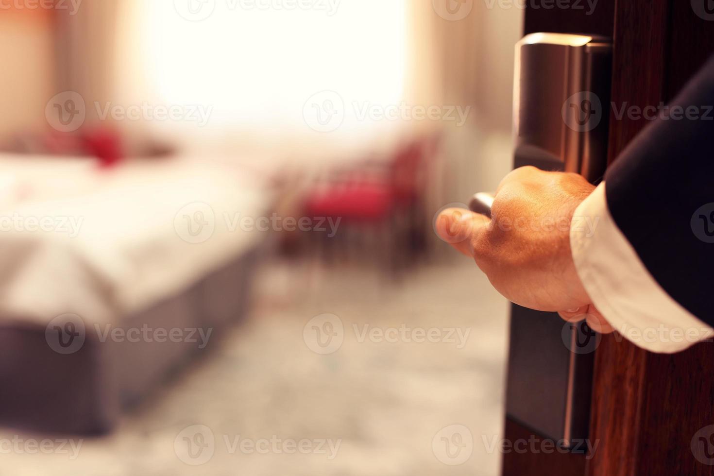 Hand of businessman opening hotel room photo