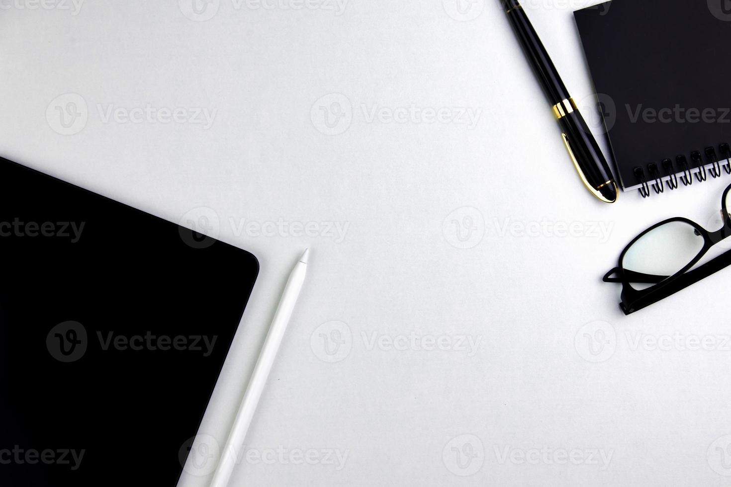 Top view modern white desk with tablet computer for graphic design, book pages and other accessories on  white background workspace concept, workspace style, online meetings, freelance work for copy photo