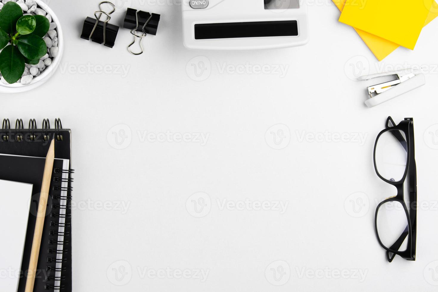 top view of modern white office desk with computer keyboard, blank notebook page and other equipment on white background. Workspace concept, workspace management style, business design space with copy photo