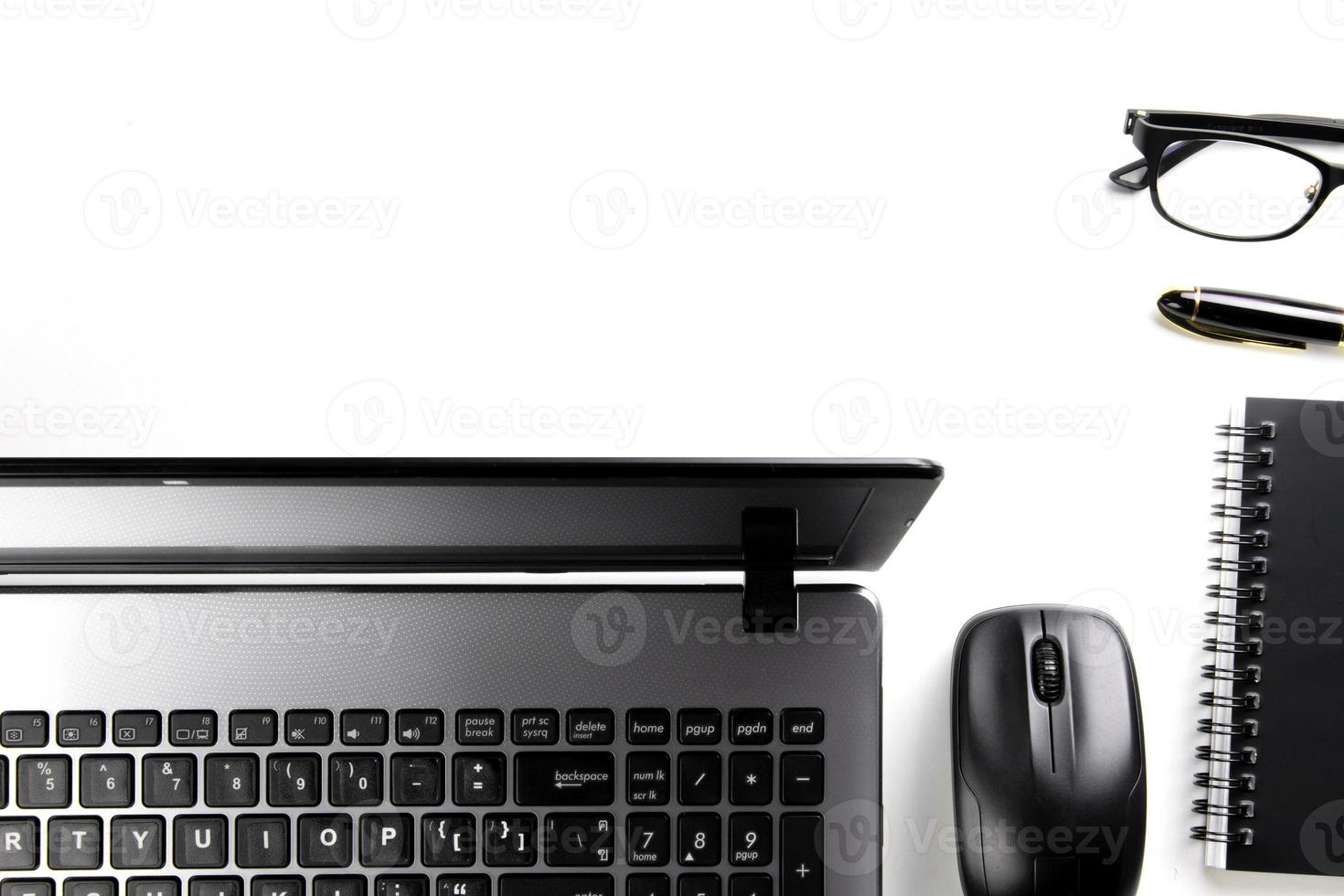 top view of modern white office desk with computer keyboard, blank notebook page and other equipment on white background. Workspace concept, workspace management style, business design space with copy photo