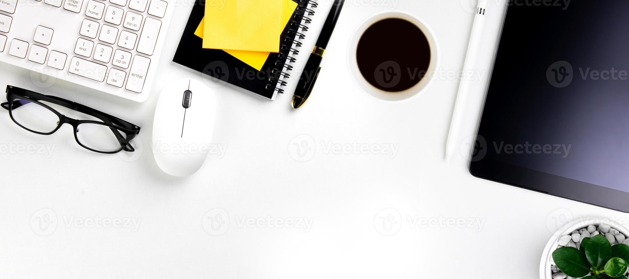 top view of modern white office desk with computer keyboard, blank notebook page and other equipment on white background. Workspace concept, workspace management style, business design space with copy photo