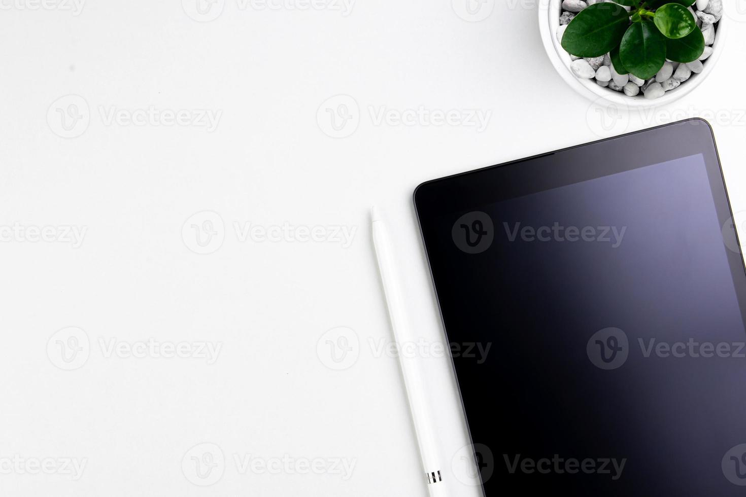 Top view modern white desk with tablet computer for graphic design, book pages and other accessories on  white background workspace concept, workspace style, online meetings, freelance work for copy photo