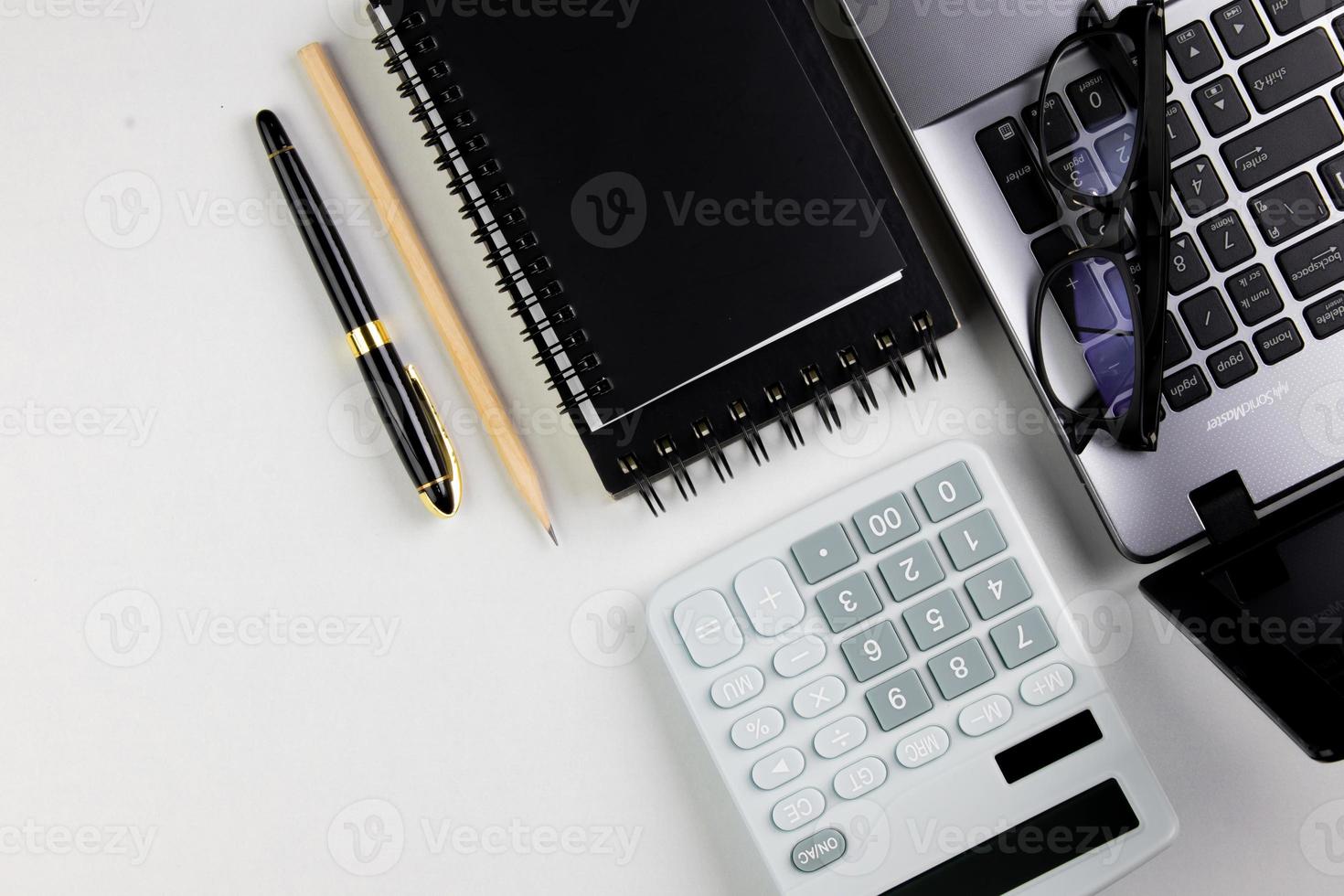 top view of modern white office desk with computer keyboard, blank notebook page and other equipment on white background. Workspace concept, workspace management style, business design space with copy photo