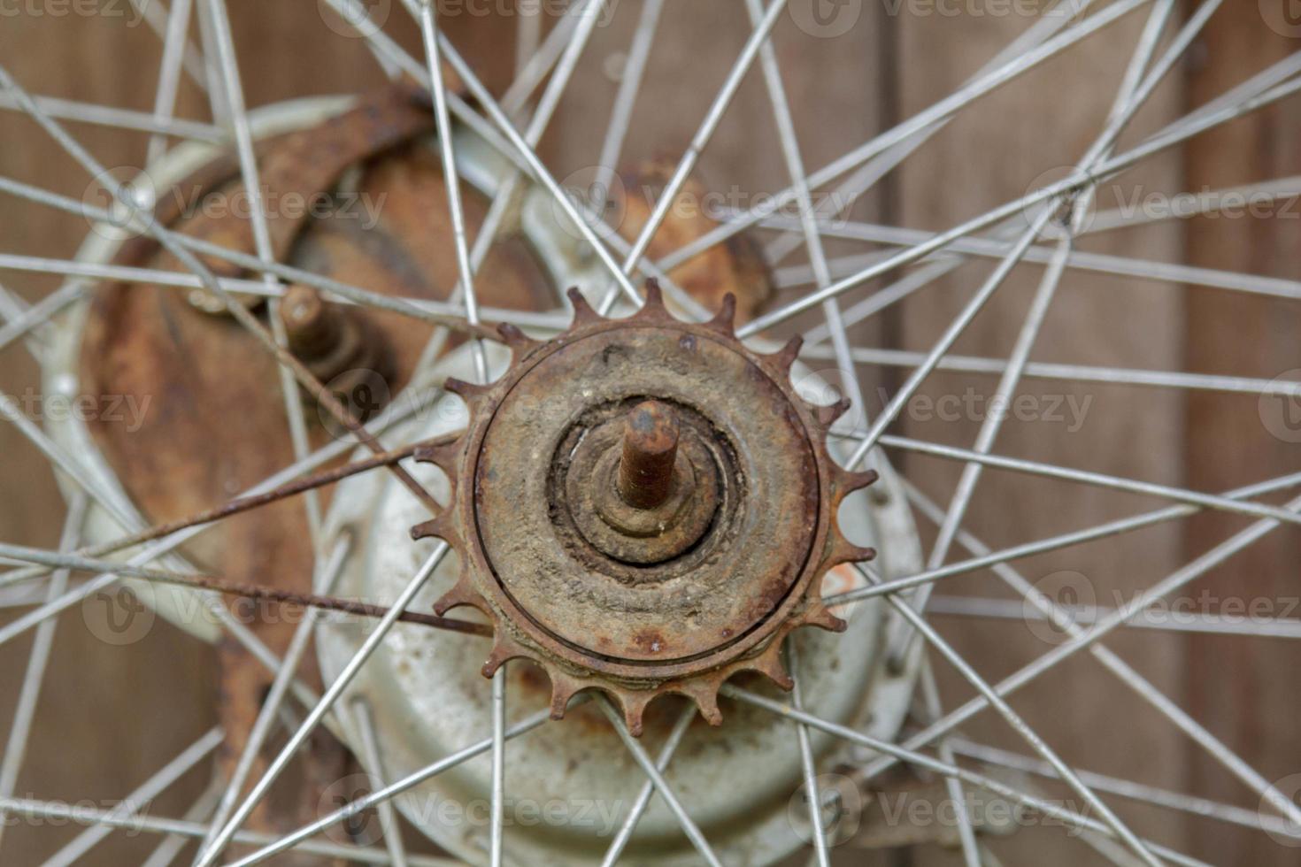 Old unused bicycle wheels stored in the back of the house, only the wire and wheel hub in the storage room with old board flooring as the back photo