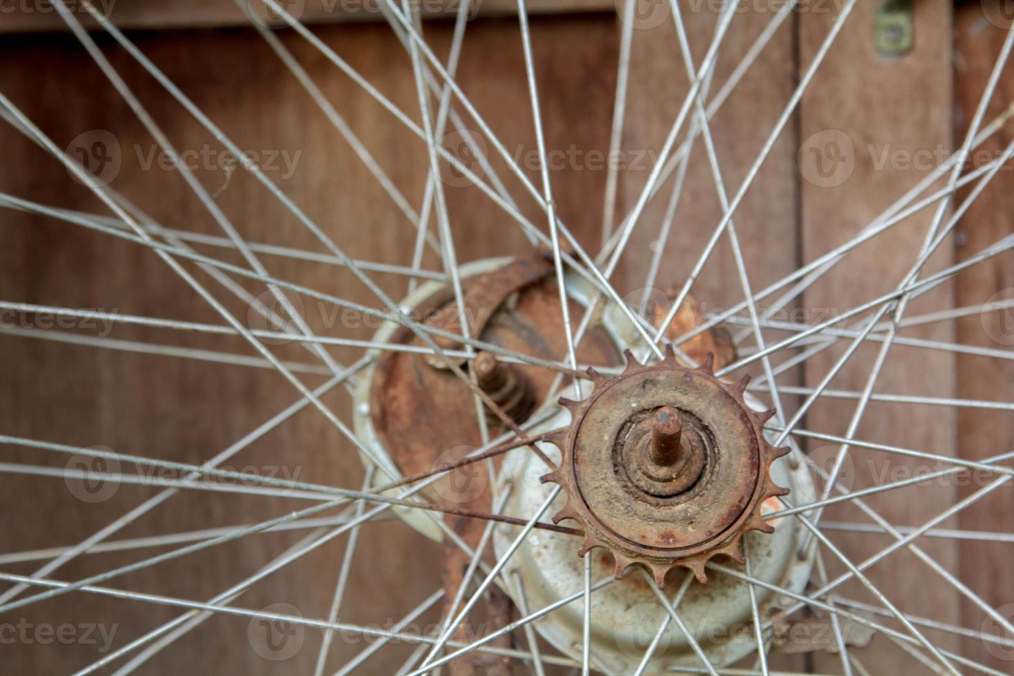 Old unused bicycle wheels stored in the back of the house, only the wire and wheel hub in the storage room with old board flooring as the back photo