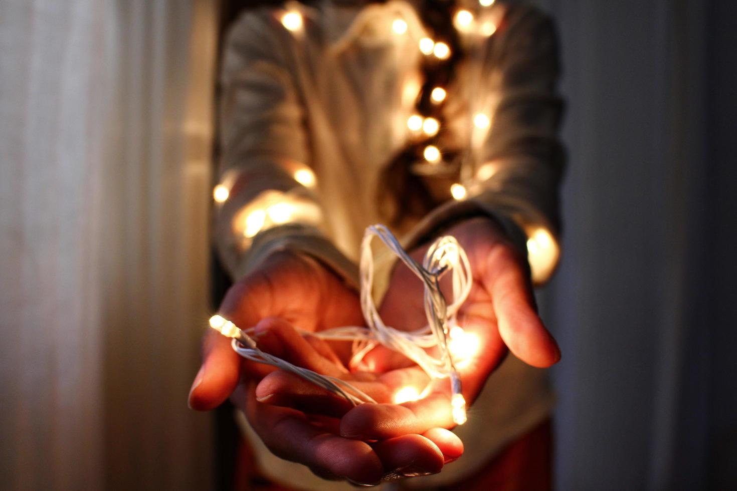 Woman holding fairy lights photo