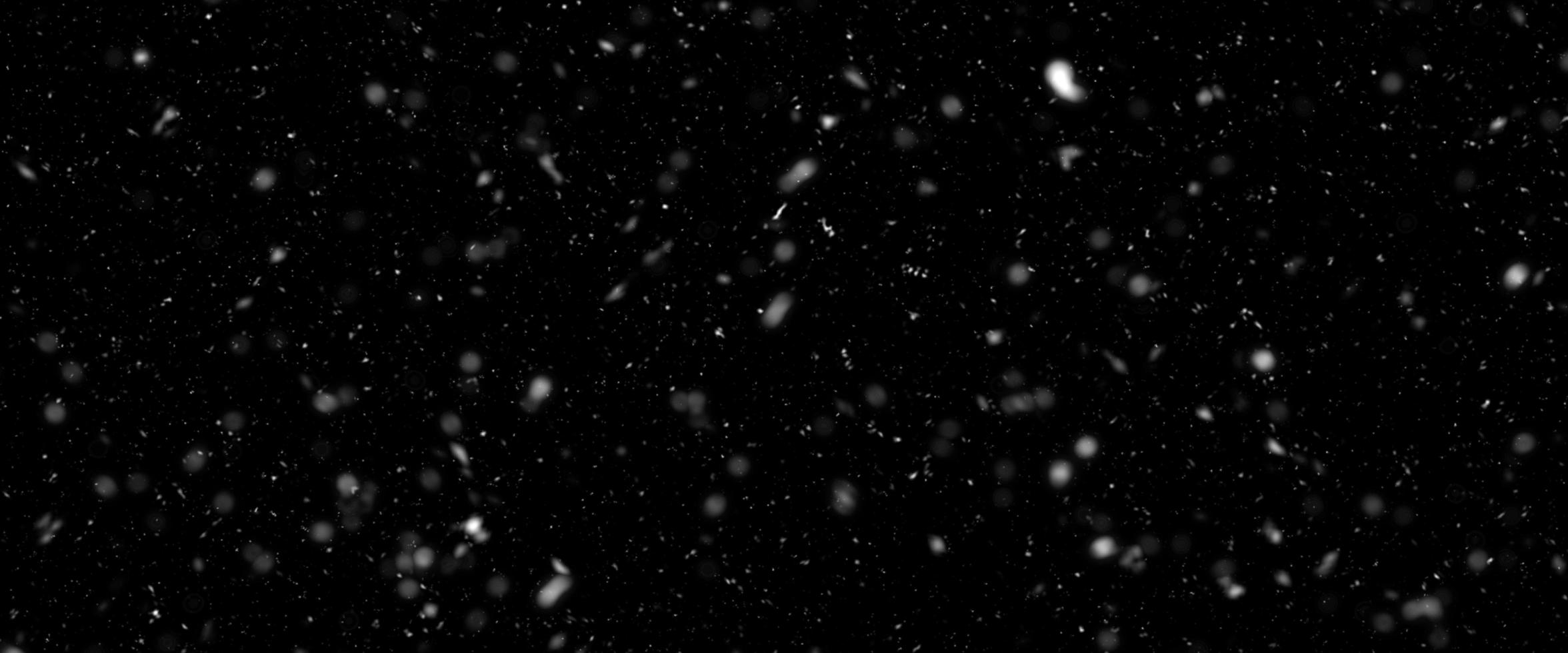 Different realistic falling snow or snowflakes. Falling snow isolated on black background. Winter snowfall illustration. Bokeh lights on black background, flying snowflakes in the air. Snow at night. photo